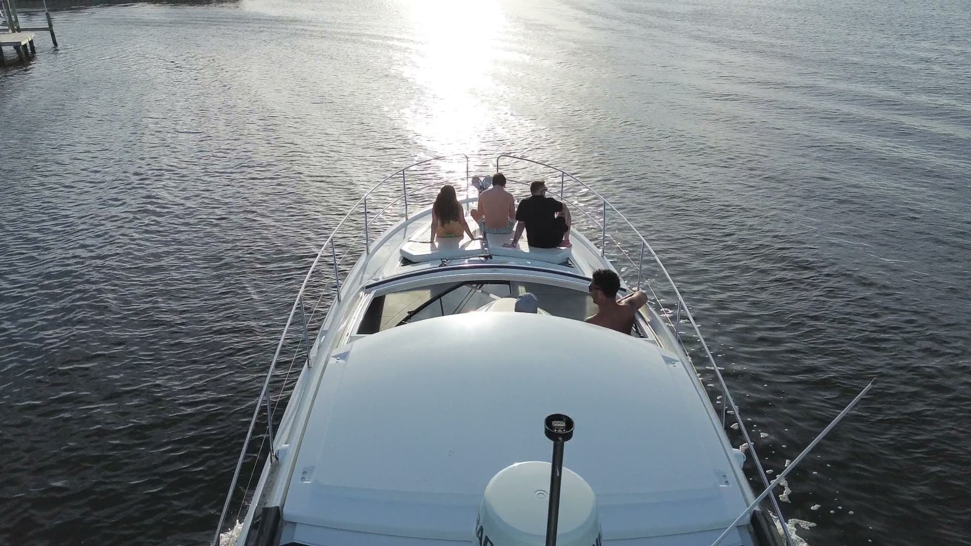 Guests on the foredeck at sunset