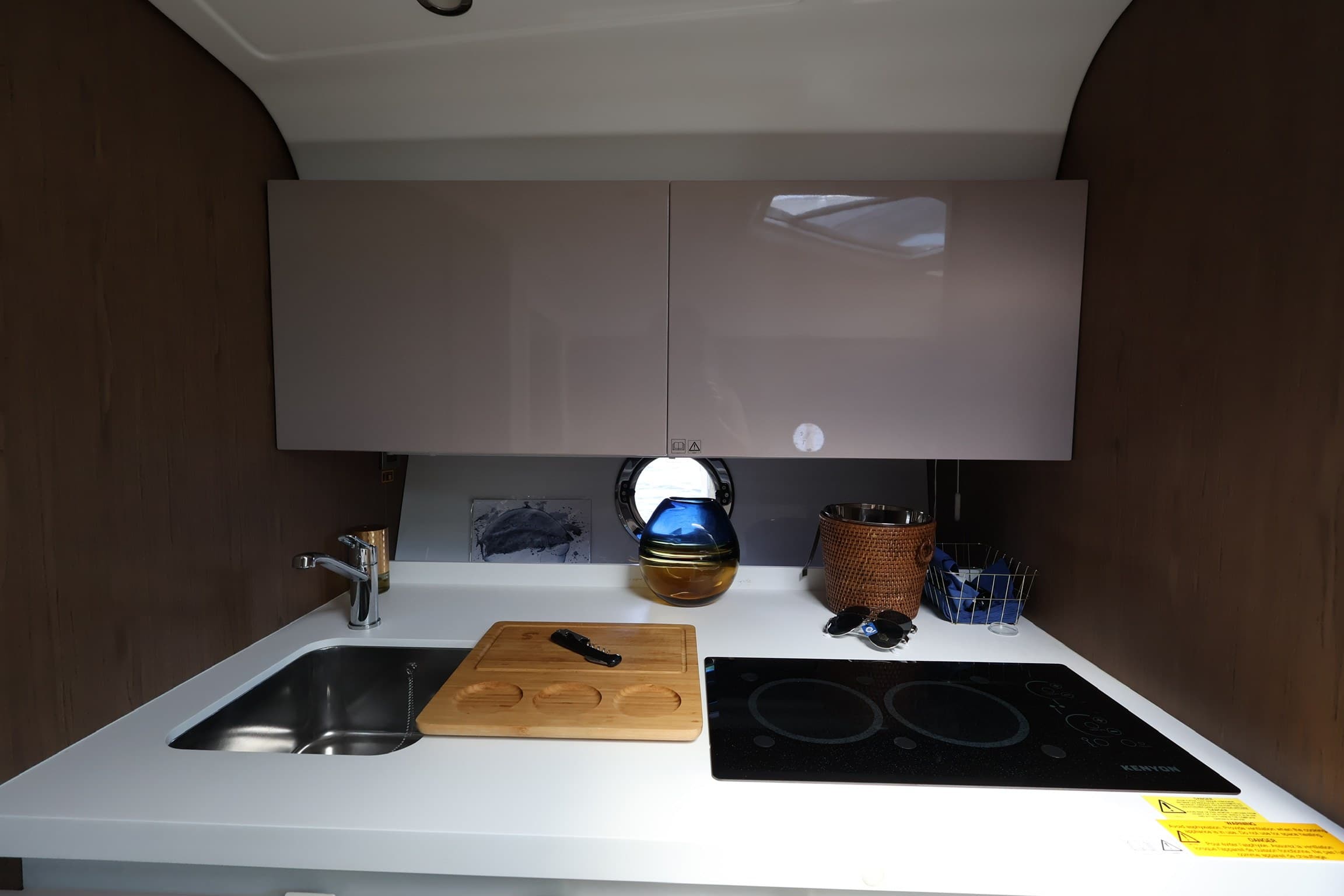 The galley with an induction cooktop and stainless sink