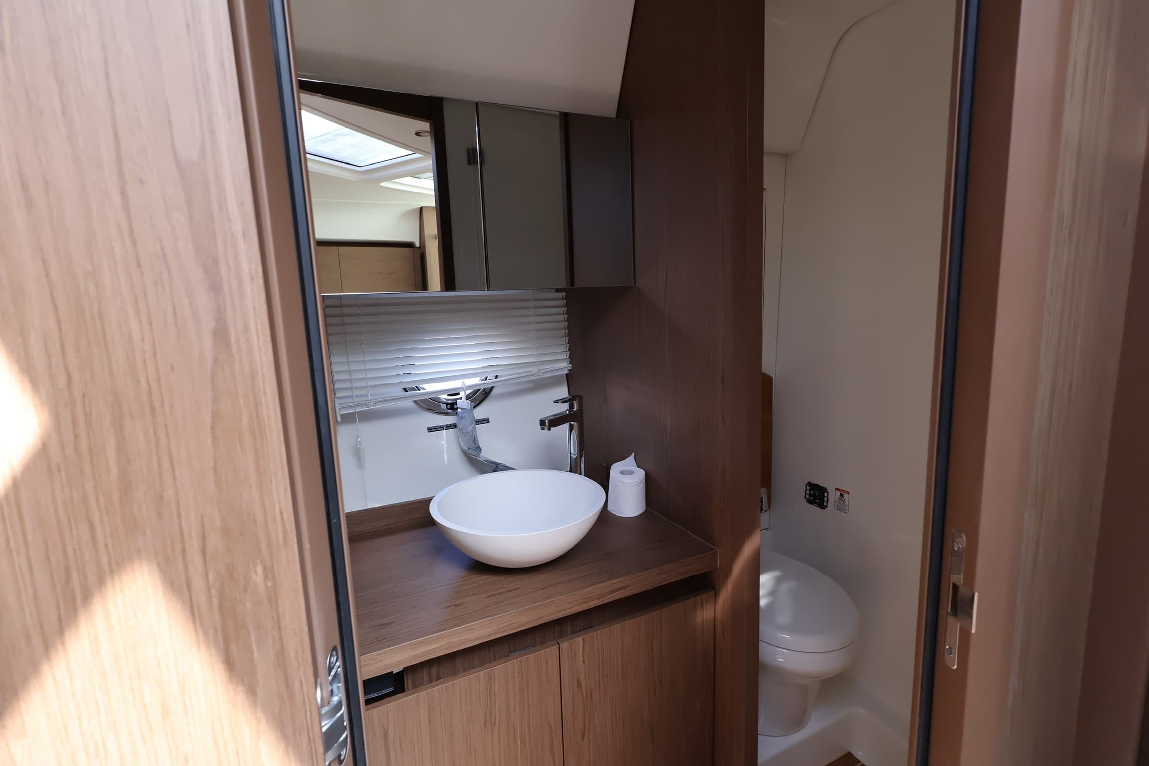 The head with a vessel sink and oak vanity