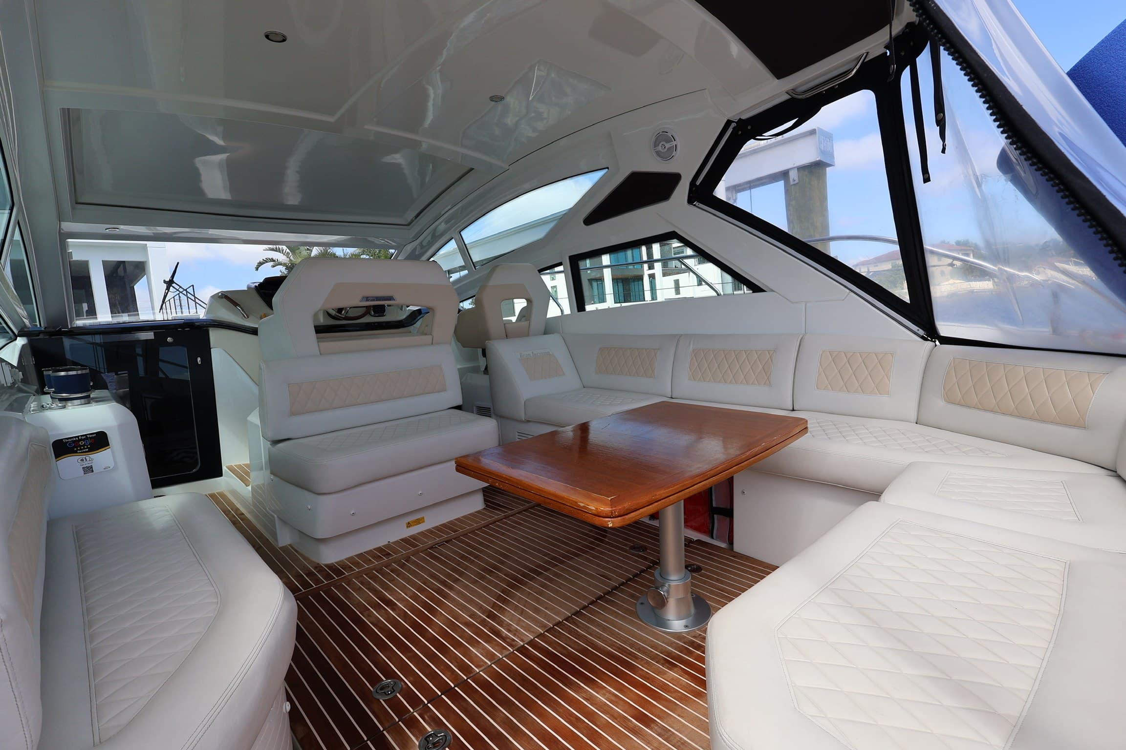 The cockpit U-lounge with a teak table under the hardtop
