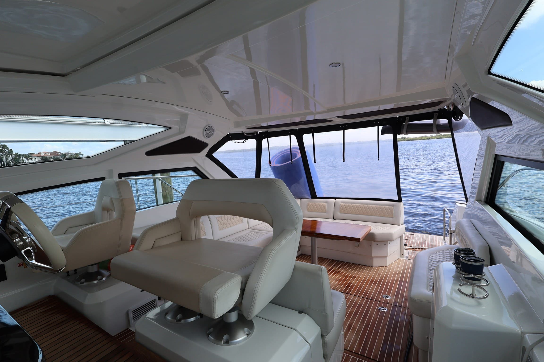 Helm seats looking aft across the cockpit lounge to open water